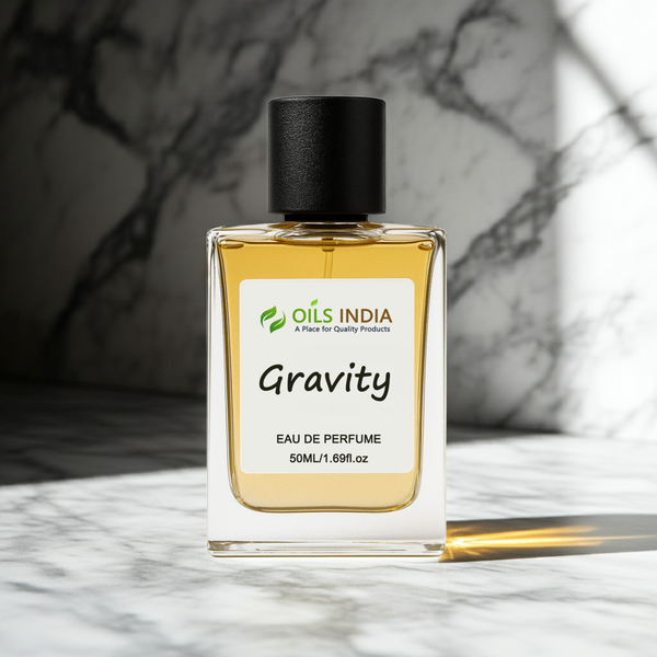 Perfume bottle labeled 'Gravity' by Oils India on a marble surface with a blurred background