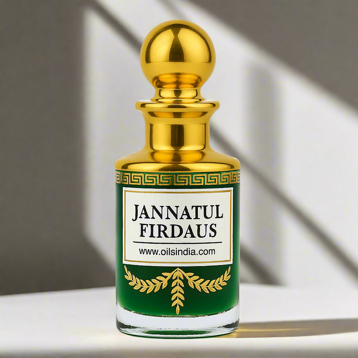 Bottle of Jannatul Firdaus with gold cap and white label on a reflective surface green colour attar in the bottle by oils india.