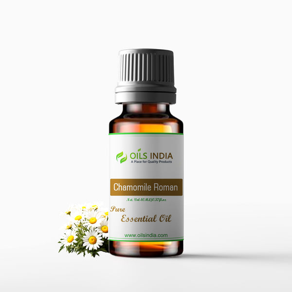 A bottle of Chamomile Roman Essential Oil with a label that reads 'Chamomile Roman' and 'Pure Essential Oil'. The bottle is accompanied by a small number of white and yellow chamomile flowers.