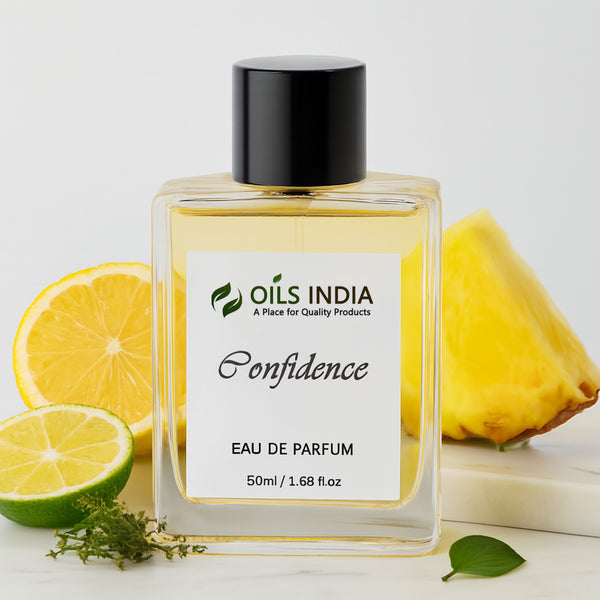 Perfume bottle labeled 'Oils India Confidence Eau De parfum' with lemons and a pineapple on a light background