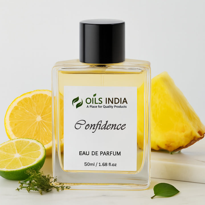 Perfume bottle labeled 'Oils India Confidence Eau De parfum' with lemons and a pineapple on a light background