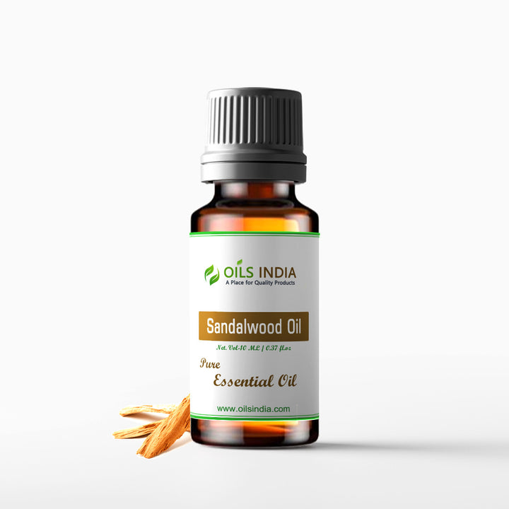 A bottle of Sandalwood essential oil with a label that reads 'Sandalwood Oil - Pure Essential Oil' from Oils India.