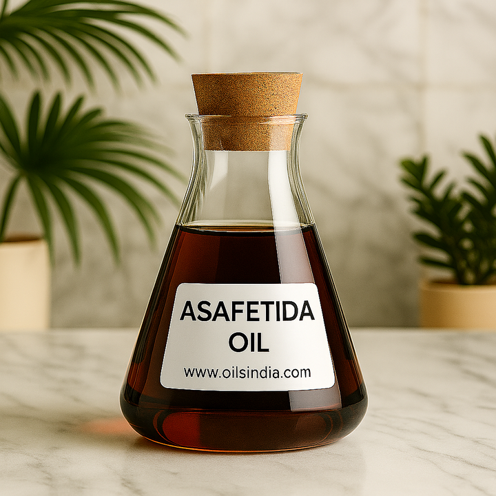 Clear glass bottle of asafetida oil with a cork lid on a marble surface, plants in the background by Oils India.