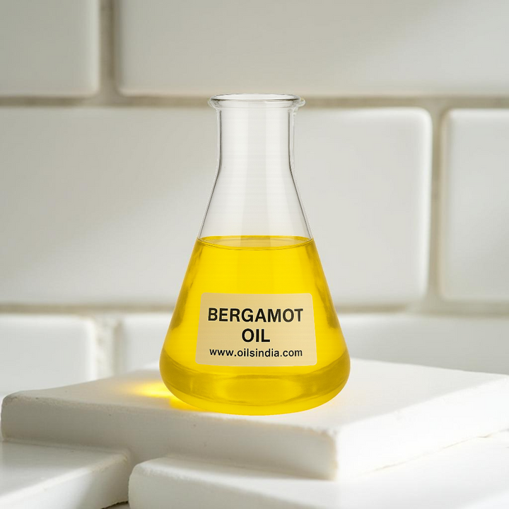 Bottle of bergamot oil by oils india on a white surface with a tiled background