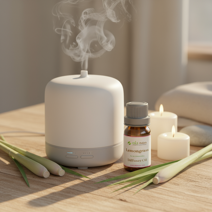 Aromatherapy diffuser with lemongrass oil bottle and candles on a wooden surface