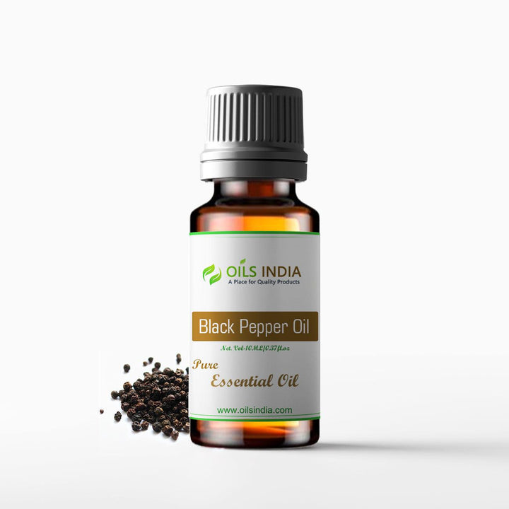 Bottle of Black Pepper Oil from Oils India with black peppercorns on a white background